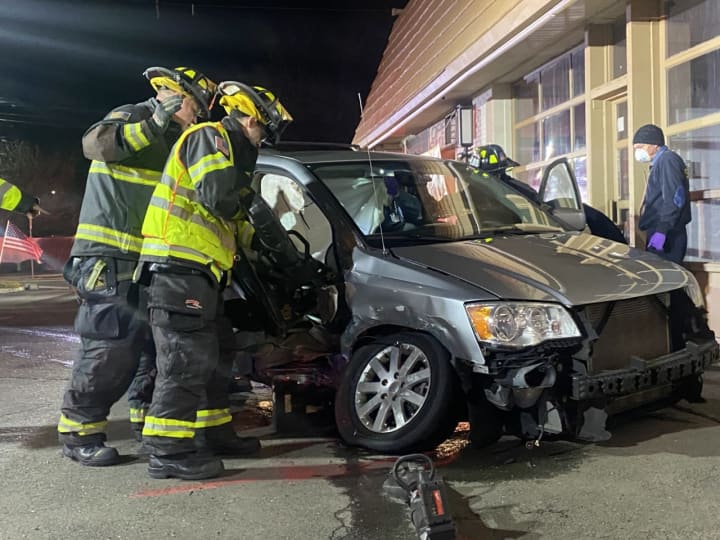 Ridgewood firefighters extricate the minivan passenger.