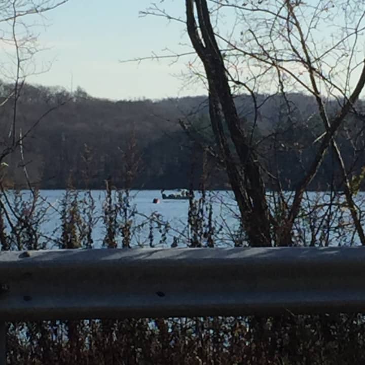 Investigators patrol the Titicus Reservoir in their search for parts of the plane that crashed.