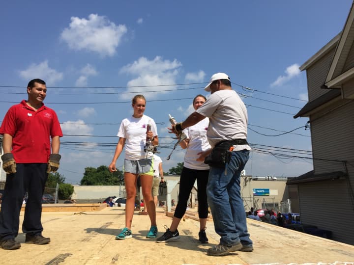 Volunteers for Habitat for Humanity of Coastal Fairfield County work on a wall raising for a home in Bridgeport last summer