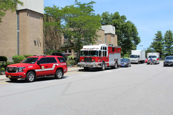 Mahopac Falls Fire, along with mutual aid ambulance from Mahopac Fire Dept. line up along the curb in front of the High School.
