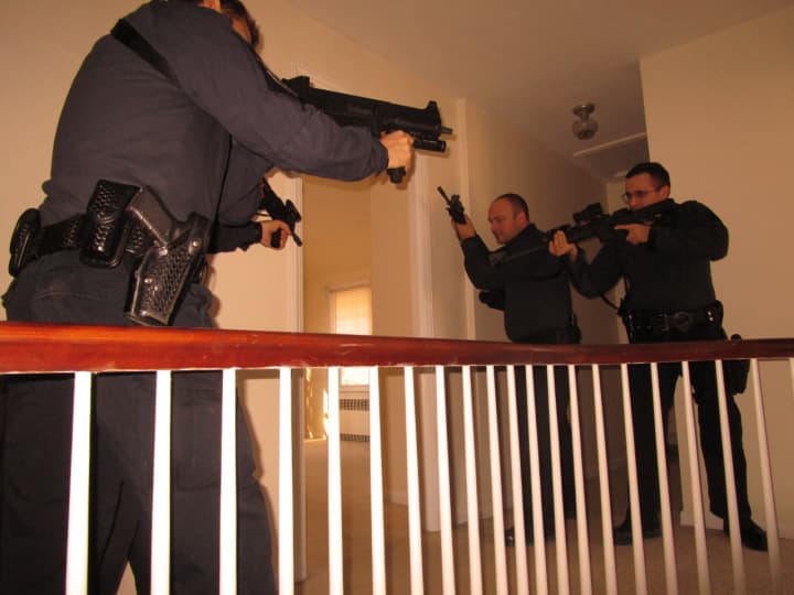 Ridgewood Officers Anthony Mormino and Joseph DiBenedetto and Sgt.Jay Chuck prepare to enter a room during a SWAT training exercise.