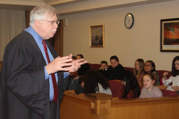Beacon seventh-grade students listen to Dutchess County Court Judge Peter M. Forman.