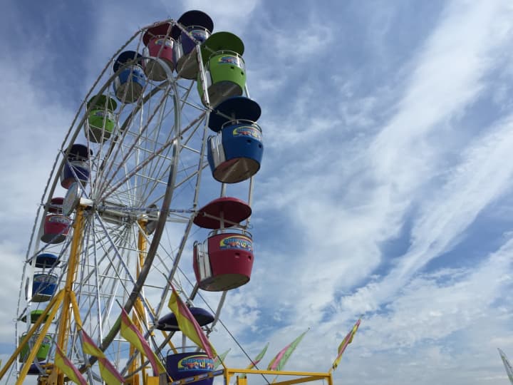 A ferris wheel spins below a perfectly blue sky at the Oyster Festival Saturday. 