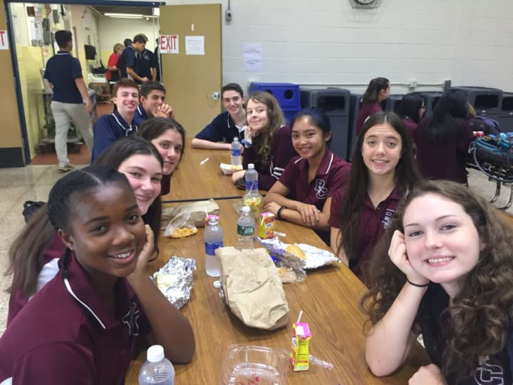 Freshmen and upperclassmen eat lunch together on the first full day of school at Burke Catholic High School.