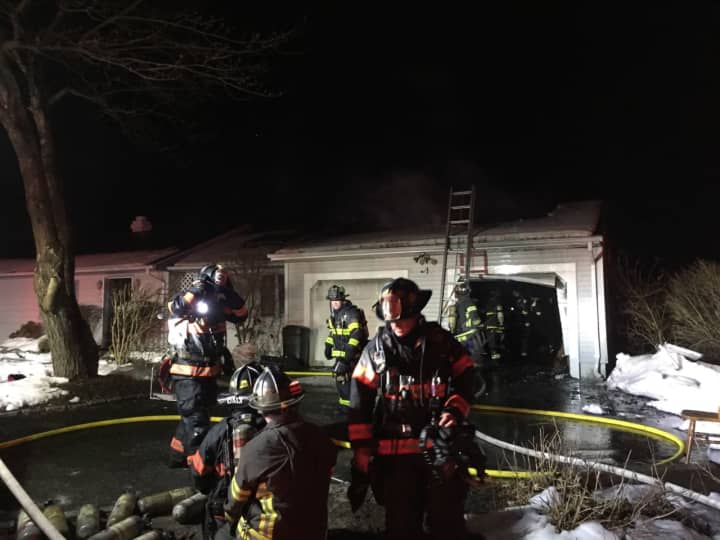 Firefighters battle the blaze that broke out just before 1 a.m. Saturday at 8 Indian Spring Road in the Candlewood Lake area.