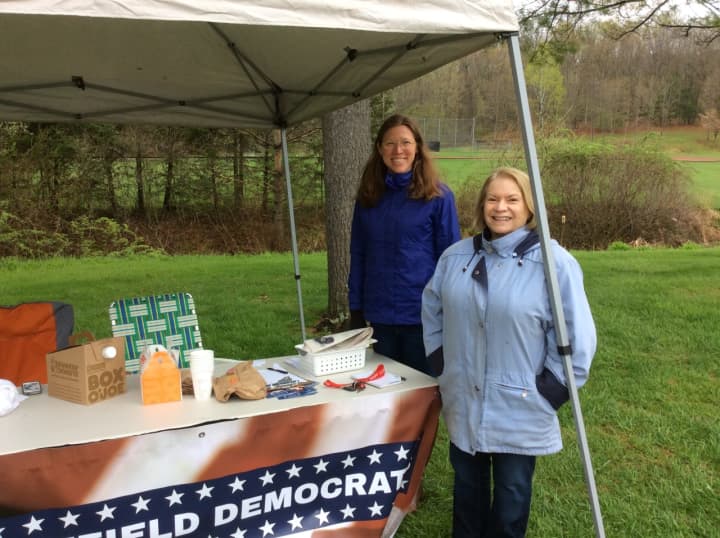 Eileen Koch and Susan Amlung of the Brookfield Democrats brave the chilly rain to offer information at the polling place at Huckleberry Hill Elementary School on Tuesday.