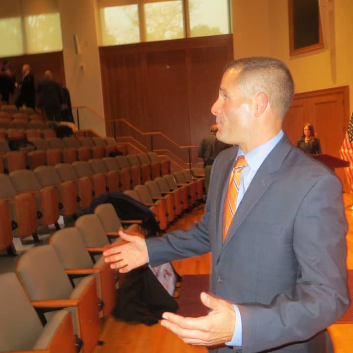 Dutchess County Executive Marc Molinaro talks to several county employees on Wednesday after he introduced his tentative budget for 2016 at Fusco Recital Hall, Marist College. It includes more money for tourism and major bridge and road projects. 