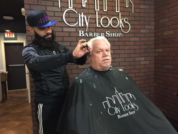 A barber works his magic in City Looks in Oradell