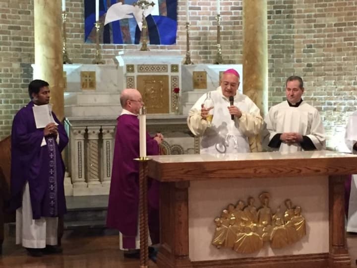 Bishop Nicholas DeMarzio consecrates the altar at The Shrine Church of Our Lady of Solace in Coney Island. The church was badly damaged by Superstorm Sandy in 2012.