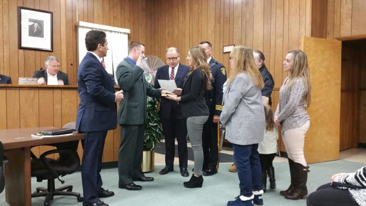 East Rutherford Mayor James Cassella swears in William Zito while Police Commissioner Brizzi (far left) and Zito&#x27;s family look on.