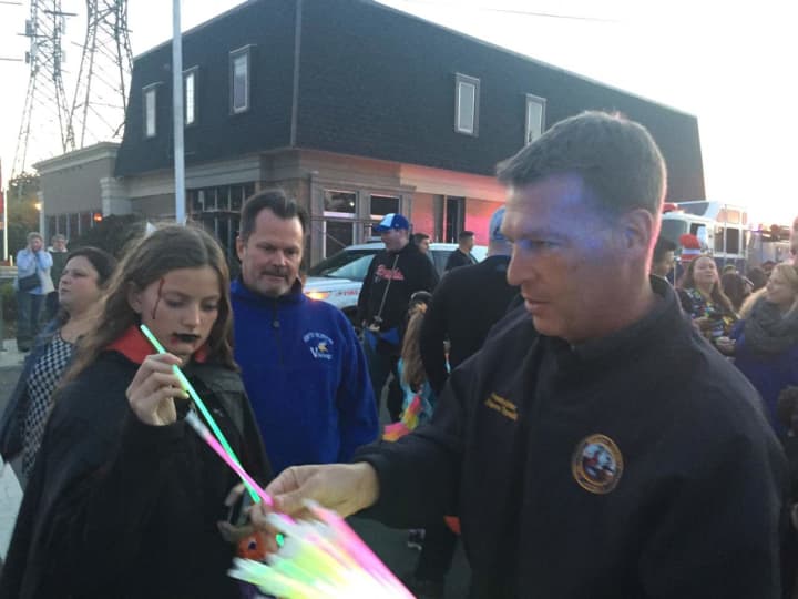 Bergen County Freeholder Steve Tanelli hands out glow sticks.