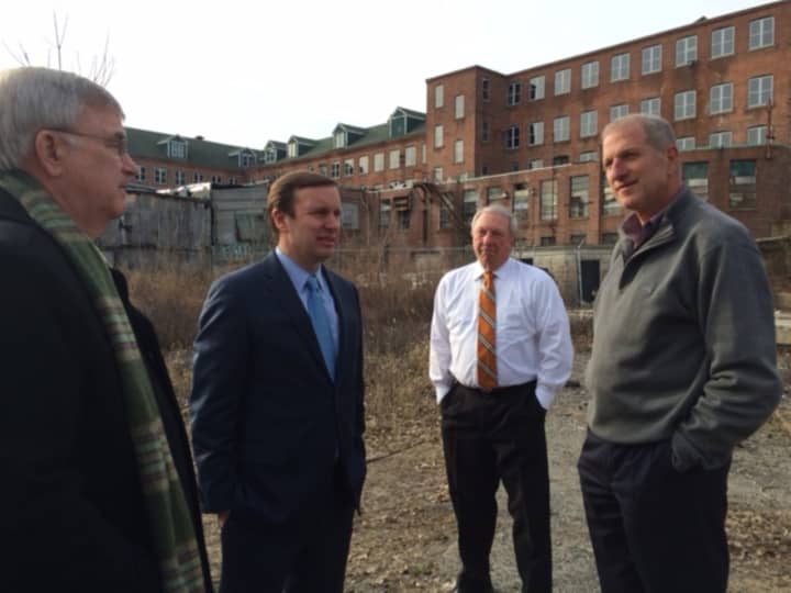 James Ryan, president, Shelton Economic Development Corp., U.S. Sen. Chris Murphy and Shelton Mayor Mark Lauretti, far right, discuss the city&#x27;s waterfront brownfields in which the city won an earlier $200,000 EPA grant.