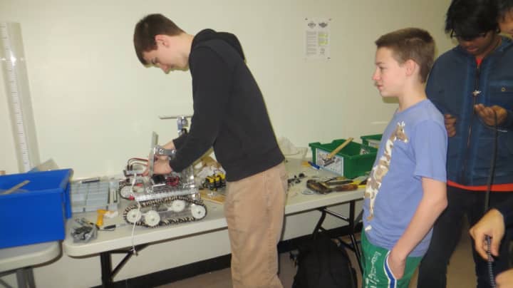 Jack Phillips, left, captain of the robotics club at Mamaroneck High School, puts some finishing touches on this year&#x27;s robot entered in a Saturday First Tech Challenge competition at John F. Kennedy Catholic High School.