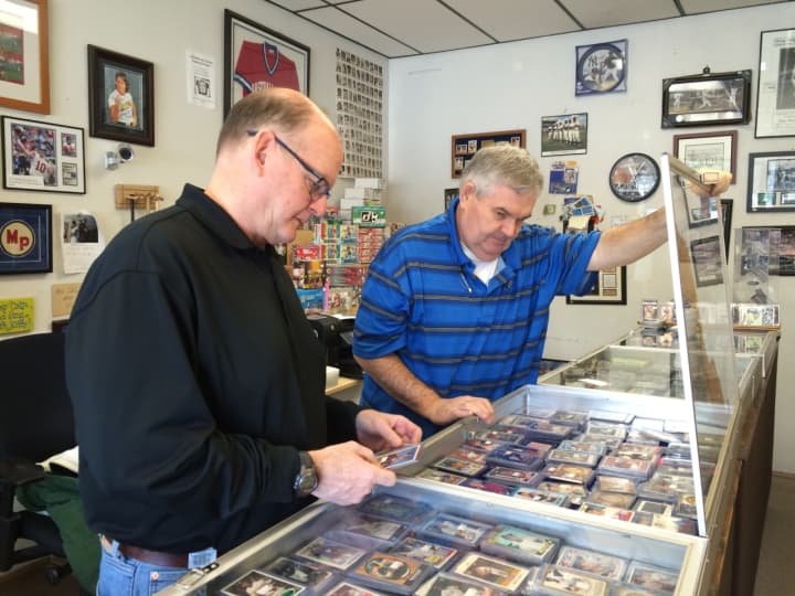 Mike Healy, at left, and Dave Lancaster look through their collection at The Baseball Card Store in Midland Park.