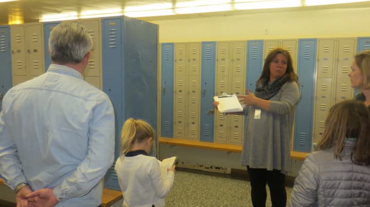 Mamaroneck Athletic Director Bari Suman shown giving a tour of antiquated locker room facilities last week. On Tuesday, Mamaroneck residents overwhelmingly approved a $9 million bond issue to upgrade physical education space at the high school.