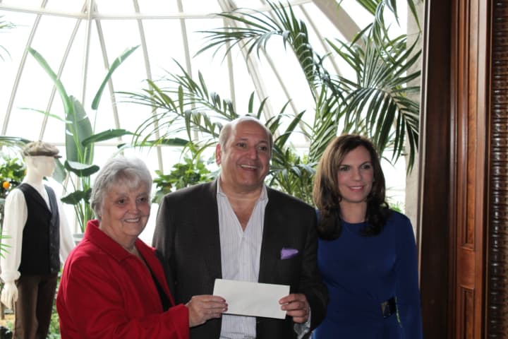 L-r: Lockwood-Mathews Mansion Museum board chairman Patsy Brescia, Klaff’s CEO Joe Passero, and the museum&#x27;s executive director, Susan Gilgore, show off the check for $8,811.90 that the design firm donated to the museum