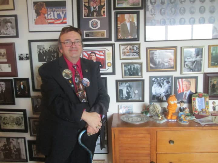 William Reynolds stands in front of his wall of presidential memorabilia.