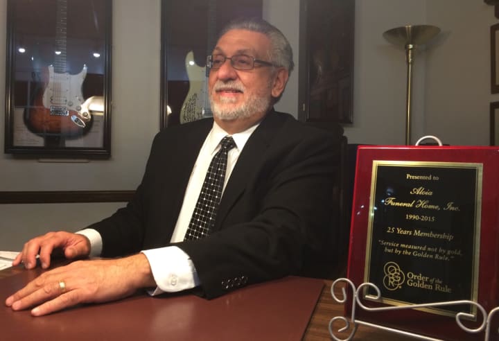 Louis Aloia sits in an office at his Garfield Funeral home.