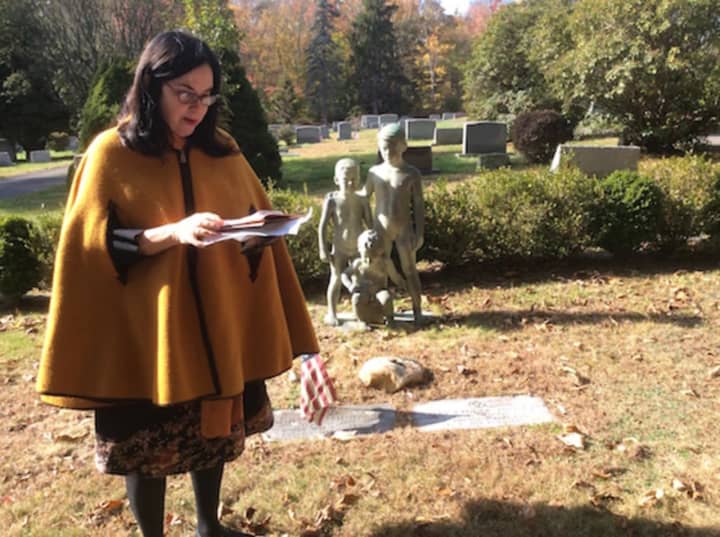 Patricia Funt Oxman consults her research during the New Canaan Historical Society&#x27;s second annual cemetery tour Tuesday, Nov. 1.