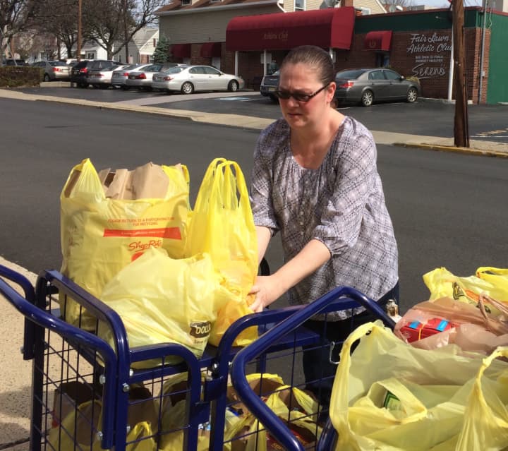 Laura Sabatello loads groceries at the Fair Lawn Food Pantry Wednesday.