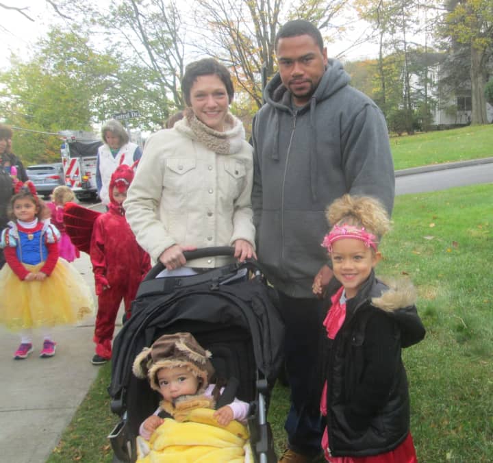 A monkey and Princess Elena pose with their parents at the Briarcliff Ragamuffin Parade.