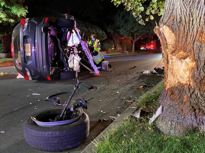 The vehicle slammed into a tree and rolled onto its side near the intersection of Linwood Avenue and North Walnut Street in Ridgewood.