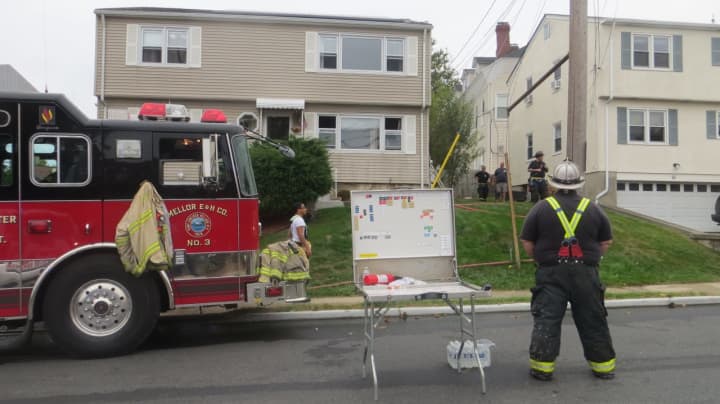 Port Chester firefighters outside a home at 14 Summit Ave. that was damaged by a fire on Thursday afternoon.