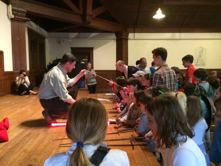 Mark Silence, a theater teacher at Stamford&#x27;s King School, shows children a range of theater swords at the Shakespeare Family Festival at Fairfield&#x27;s Pequot Library.