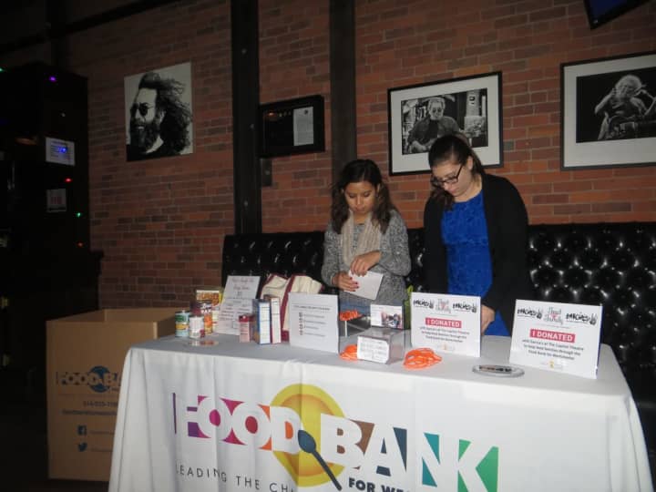 Kristina Magana, left, and Madeline Sulla of the Food Bank For Westchester collected non-perishable goods on Wednesday night during a holiday concert at Garcia&#x27;s at The Capitol Theatre in Port Chester. The Cap plans more charity events next week.