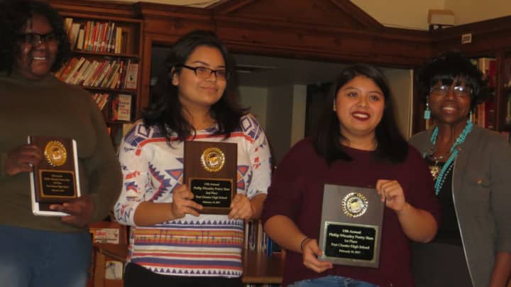 From left, Port Chester High School poetry slam winners Mailynn Dempson, Karen Pantoja and Adriana Siguenza with Mattie Gooden.