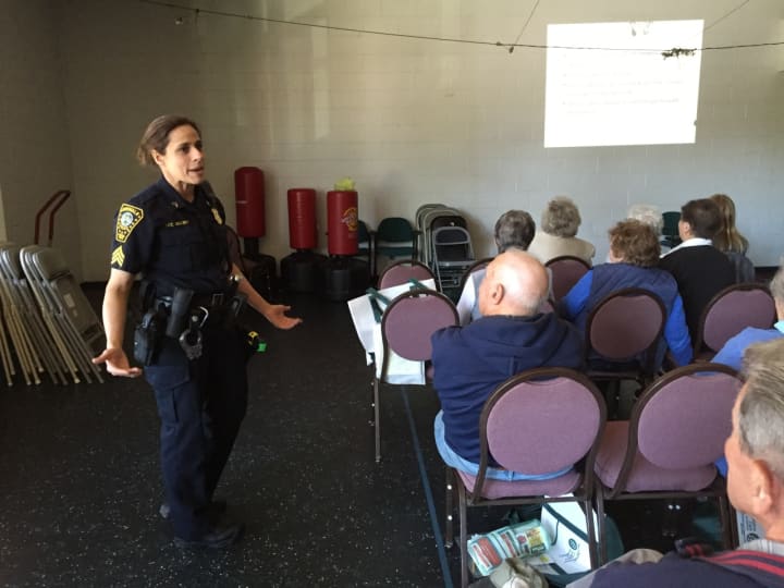 Sgt. Sofia Gulino of the Norwalk Police Department talks to seniors on Wednesday.