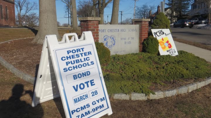 A placard outside Port Chester High School reminds residents to vote for the $80 million schools&#x27; renovation bond. The projects are eligible for about 66 percent reimbursement in state aid.