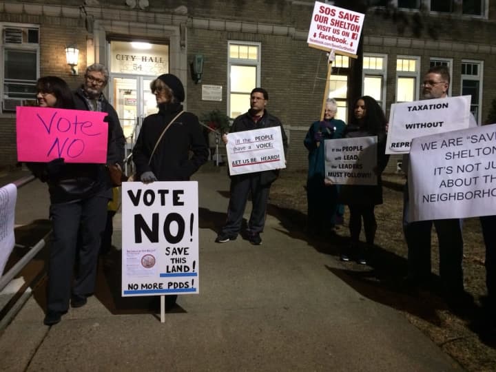 Protesters from Save Our Shelton line up outside Shelton City Hall on Thursday evening to urge a &quot;no&quot; vote on the proposed development, Towne Center at Shelton Ridge.