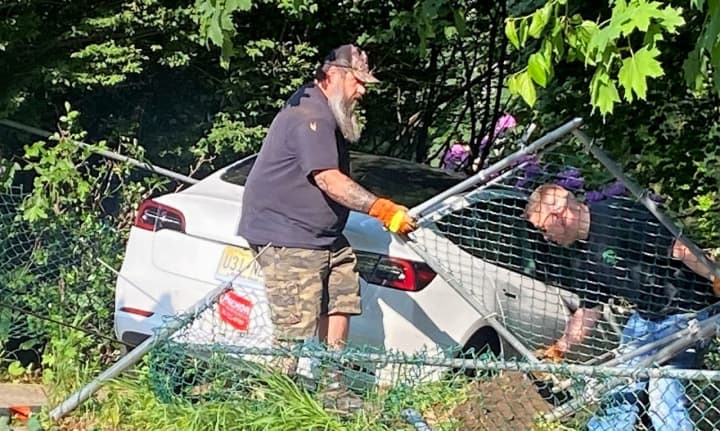 Two Emerson Towing employees had to remove a section of fence before they could tow the vehicle out and onto a flatbed following the crash at Mill Street and First Avenue in Westwood around 5 p.m. Tuesday, May 23.
