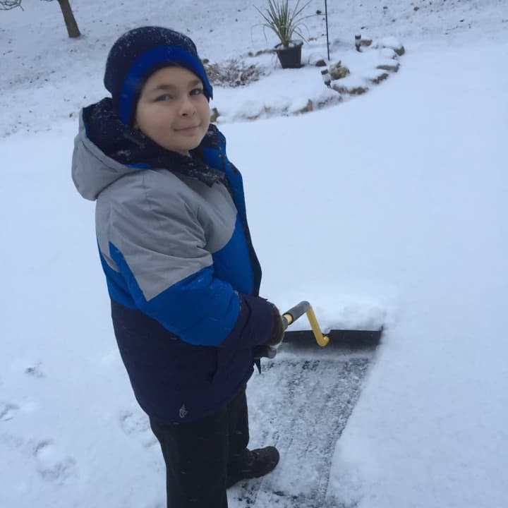 A member of the Mcevoy family in Airmont helps to clear snow from Saturday&#x27;s storm.