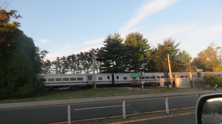A northbound commuter train passes through the Commerce Street railroad crossing in Mount Pleasant. The Valhalla crossing was the site of the deadliest crash in Metro-North history in February 2015.