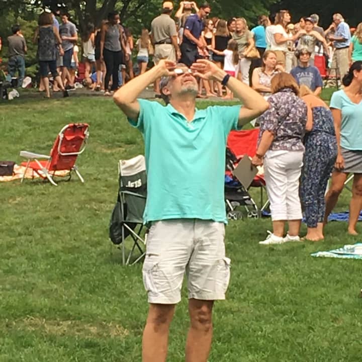 One man has his eyes on the sky to check out the eclipse — but no one else in Ballard Park in Ridgefield seems to notice!