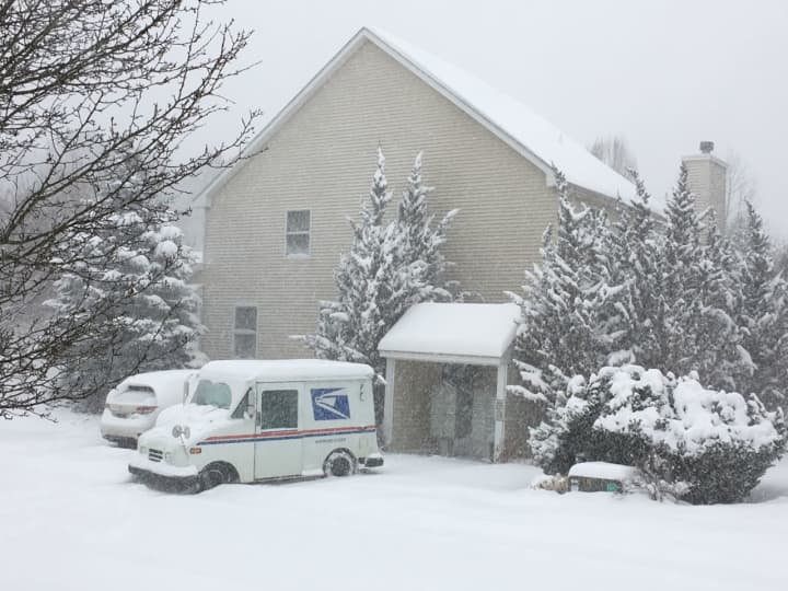 A postman makes a delivery in the last snowstorm in Trumbull. The Town declared a Snow Emergency for Tuesday&#x27;s impending blizzard.