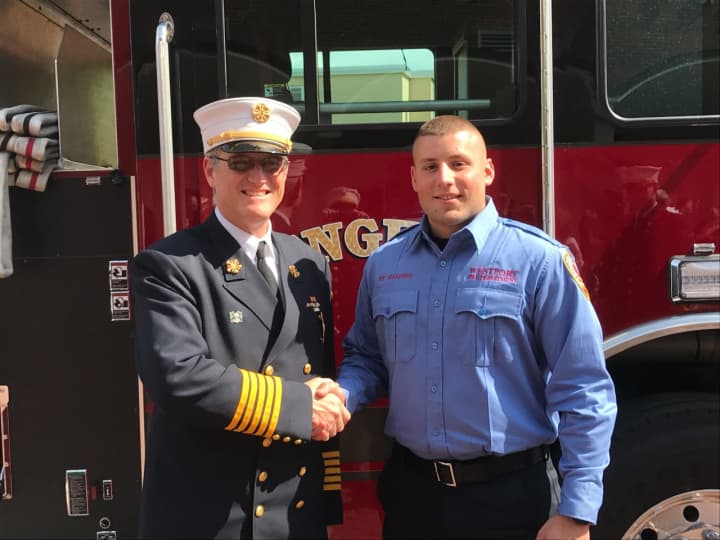 Westport Fire Chief Robert Yost congratulates Nicholas Marenna, who graduated from the Connecticut Fire Academy.