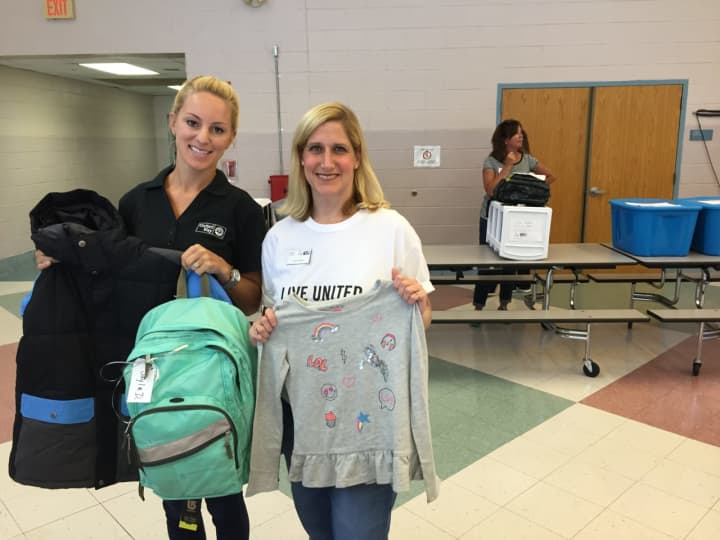 Nicole Granskog and Tessi Ruggeri of the United Way of Western Connecticut hold up school supplies donated to children in need on Tuesday.