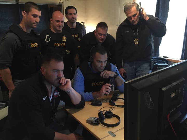 Fairfield Police officers watch the &#x27;Predator&#x27; suspects on television monitors.
