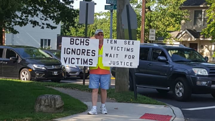 A picketer stands outside of Bergen Catholic High School in Oradell Thursday morning.