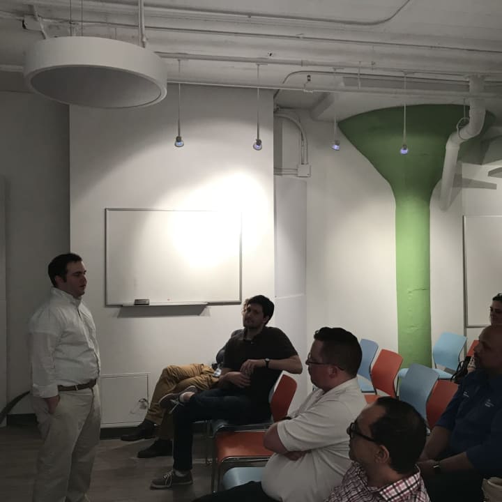 Michael McClure (standing) shares coding insights during one of Crashcode&#x27;s HackNight events in Stamford.