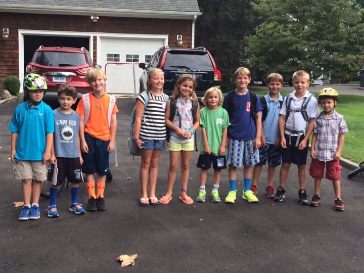 Students wait at the Echo Valley bus stop for the first day of school at Holmes Elementary School in Darien.