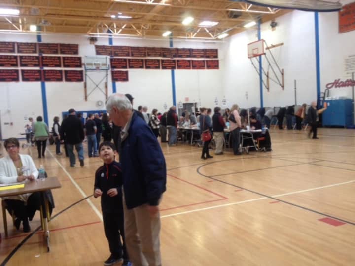 Voters of all ages spread out in the gym at Danbury High School to vote on Tuesday.