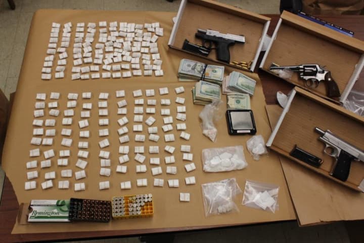 Police seized heroin, cocaine, and guns during a drug bust.