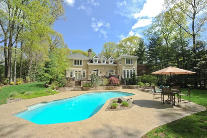 This Dimmig Road home features a heated pool and outdoor spa — right here in Upper Saddle River.