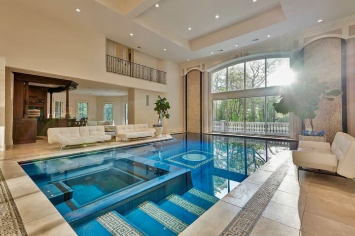 The Saddle River home features an indoor pool and outdoor courts.
