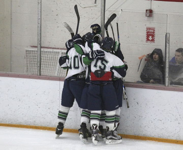 The Ice Cats celebrate one of 11 goals in a win.