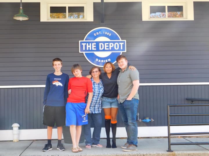 Janice Marzano, middle, with teens at the Depot.